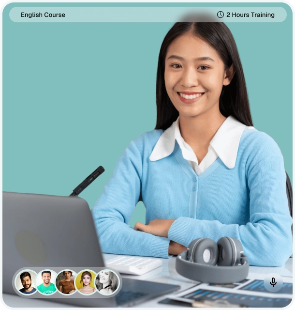 smiling woman sitting at a desk with a laptop and headset, participating in an online English course and language assessment session